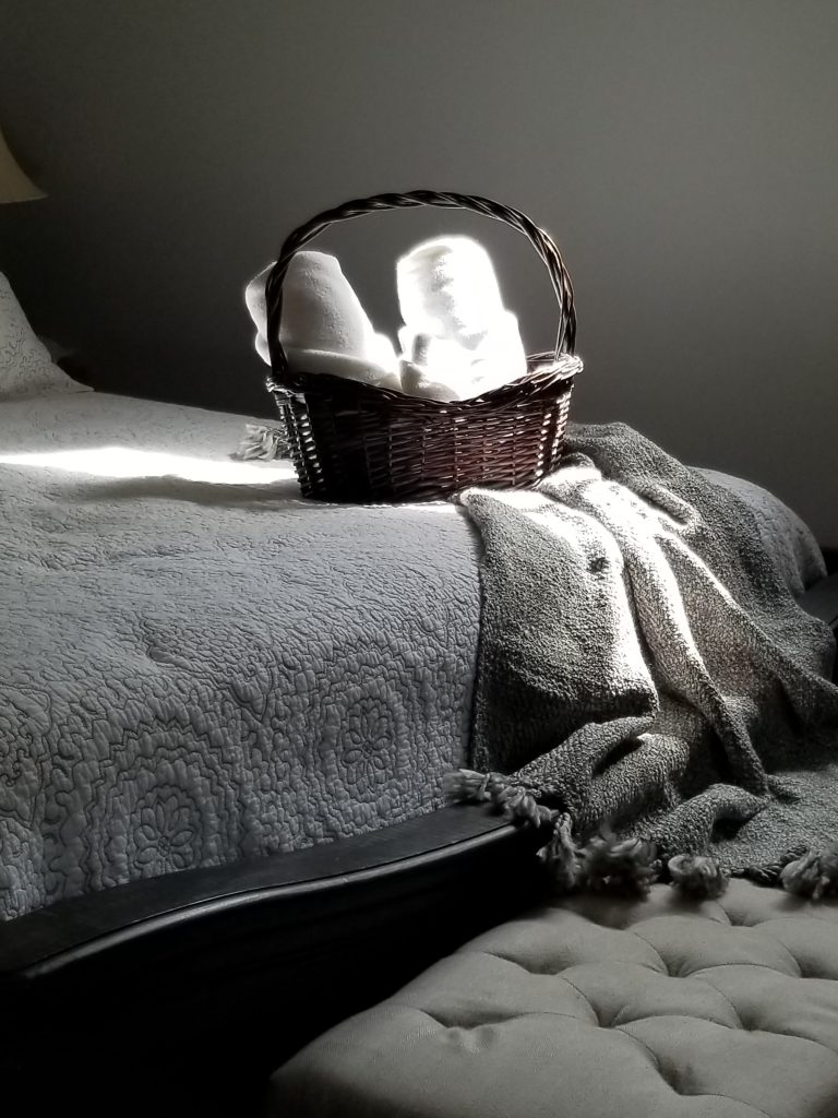 Basket with towels on a bed